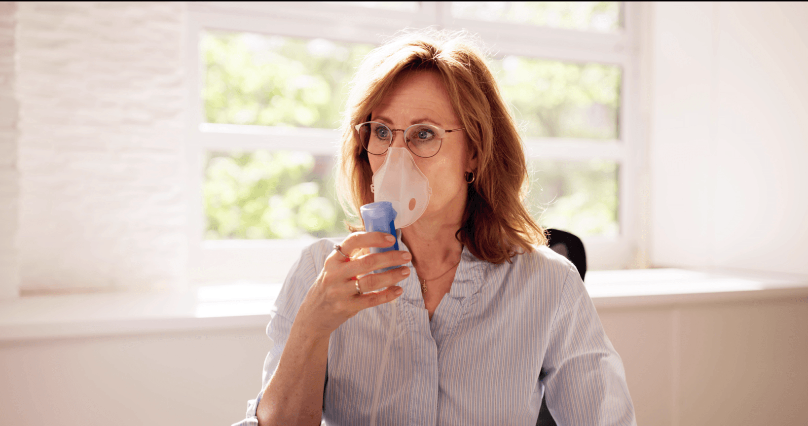 woman using nebulizer