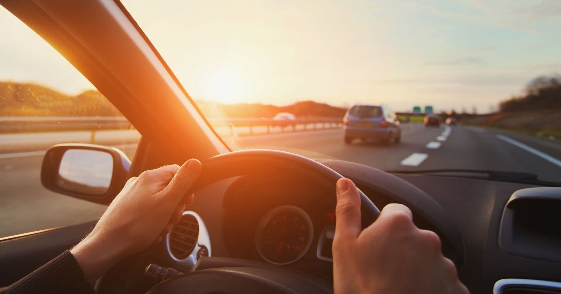 pov of someone driving into the sunset